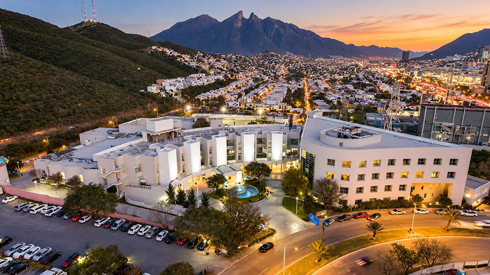 Aerial view of Hospital Angeles Valle Oriente at dusk with Cerro de la Silla, Monterrey