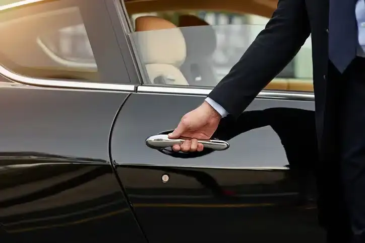 Private driver opening the car door for a patient